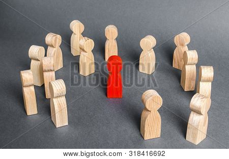 Red Human Figure Surrounded By A Group Of People. Leader Boss And Leadership. Cooperation And Teamwo