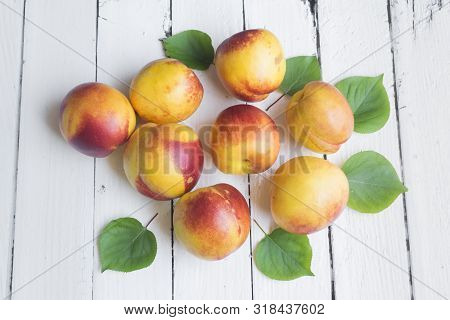 Delicious And Juicy Peach (nectarina) On White Wooden Table With Place For Text.