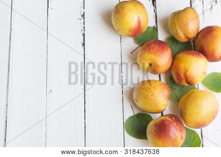 Delicious And Juicy Peach (nectarina) On White Wooden Table With Place For Text.