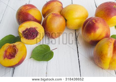 Delicious And Juicy Peach (nectarina) On White Wooden Table With Place For Text.