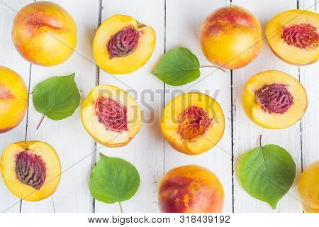 Delicious And Juicy Peach (nectarina) On White Wooden Table With Place For Text.
