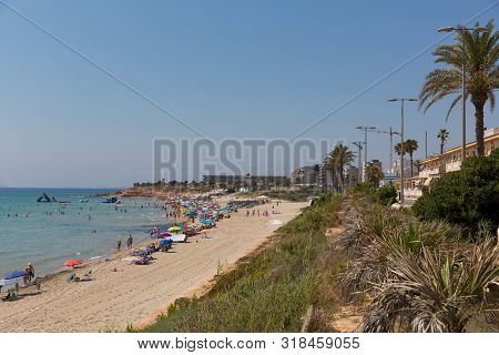 Mil Palmeras Costa Blanca Spain With People On The Beach And Palm Trees