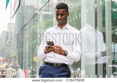 Young African American Man Traveling In New York, Wearing White Long Sleeve Shirt, Wristwatch, Stand