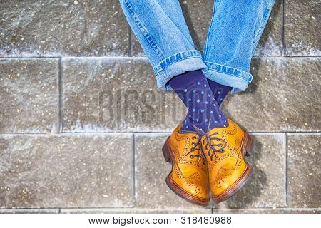 Closeup Of Mens Legs Wearing Brown Oxfords Semi Brogues Shoes. Posing Outdoors Against Stony Grunge 