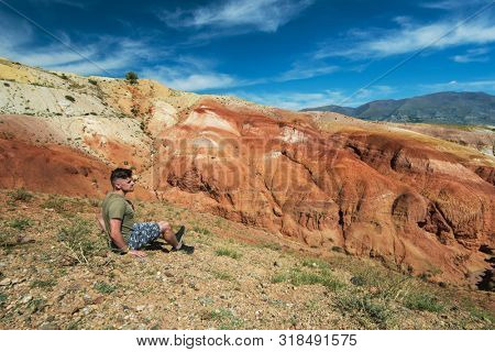 Relaxing man in Valley of Mars landscapes in the Altai Mountains, Kyzyl Chin, Siberia, Russia