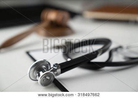 Medical Law Concept.  Gavel And Stethoscope On The Wihte Table.