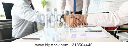 Two Adult Caucasian Business People Shake Hand Against Office Background. Pre-trial Dispute Resoluti