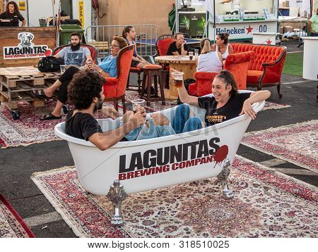 Nahariyya, Israel, August 22, 2019 : Satisfied Visitors Of The Beer Festival Sit In The Decorative B