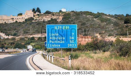 Blue Road Sign On A22 Highway Indicating The Direction Of Lisbon, Portugal