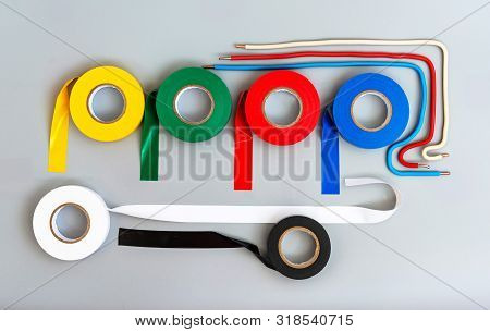 Rubber Insulating Tape Of Different Colors And Samples Of Single-core Wires On A Gray Background