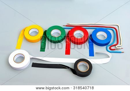 Rubber Insulating Tape Of Different Colors And Samples Of Single-core Wires On A Gray Background