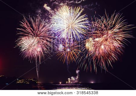 Fireworks With Silhouettes Of People In A Holiday Events.new Year Fireworks On The Beach. Travelers