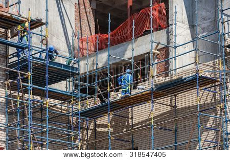 Two African workers climbed on the scaffolding on a construction site in Botswana