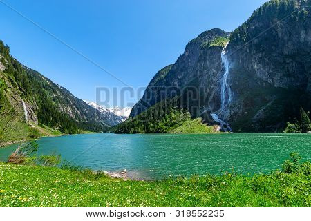 Mountain Landscape With Clear Turquoise Lake And Waterfall In The Alps. Zillertal Alps Nature Park, 