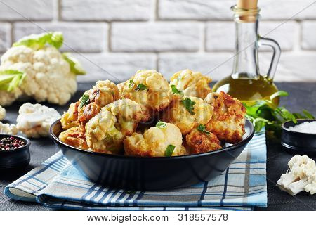 Cauliflower Florets Fried In Batter Served In A Bowl On A Concrete Table With Fresh Cauliflower And 