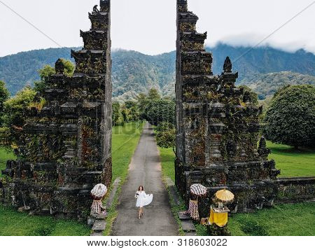 Tourist Woman Take A Photo Of Yourself With Drone Near Traditional Balinese Hindu Gate Candi Bentar 