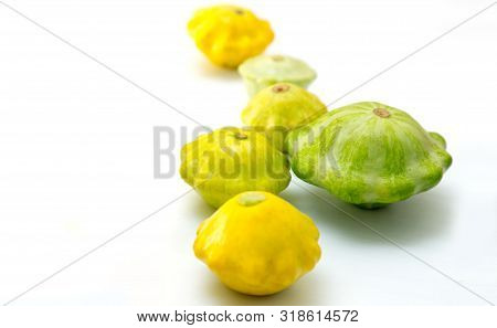 Pattypan Squashes Vegetable. Group Of Green And Yellow Pattypan Squashes, On White Table Background.