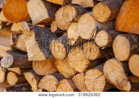 Splited Firewood For Fireplace Or Stone Campfire Stacked Together.