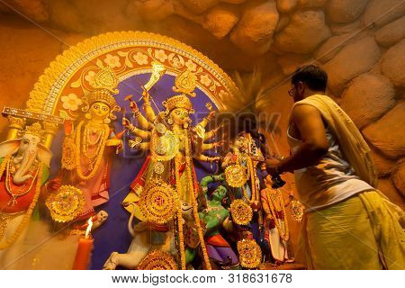 Kolkata, India - October 16, 2018: Young Hindu Priest Praying To Goddess Durga Using Chamor - A Kind
