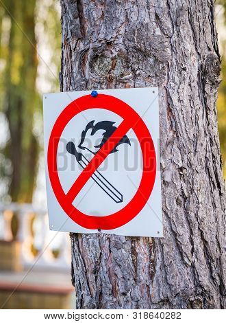 No Match Fire Sign. Red Circle With Crossed Match. Blurred Park Nature Background. Prohibition Of Li