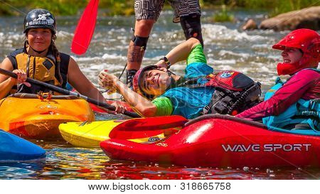 Myhiya, Ukraine - August 17, 2019: Playboating. A Company Of Young Freestyle Kayakers. A Short Break