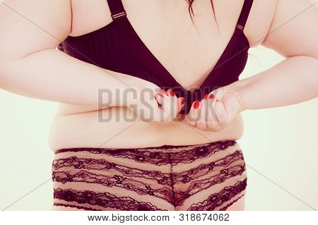 Fat Woman Wearing Black Lingerie Bra And Panties Back View. Plus Size Female Opening Taking Off Or P