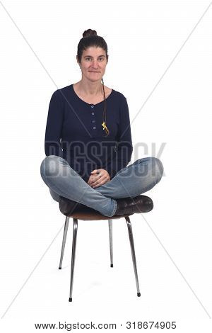 Woman Sitting In A Vintage Chair With The Lotus Pose