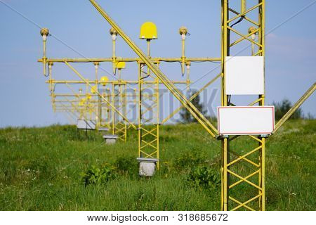 Yellow Metal Support Systems Of Care During Takeoff And Landing - Landing Direction Light Near Runwa