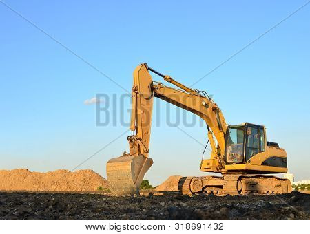 Heavy Excavator Working At Gravel Quarry Unloads Old Concrete Stones For Crushing And Recycling To G