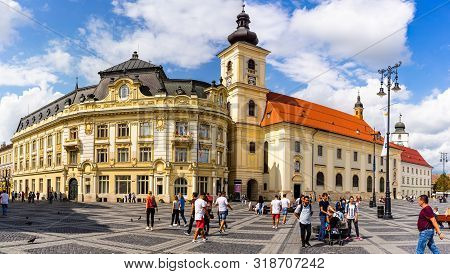Sibiu, Romania - 2019. Tourist Wondering In The Panoramic The Big Square (piata Mare) Of Sibiu Looki