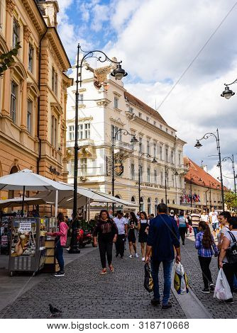 Sibiu, Romania - 2019. Tourists Wandering In The Big Square Of Sibiu (piata Mare).