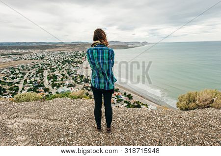 Girl Is Looking At Images Of The Region Of Comodoro In Argentina