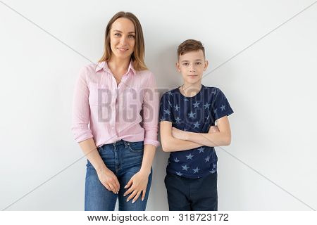Good-looking Single-parent Mom And Teen Son On White Background. Cohesion, Friendship And Family Rel