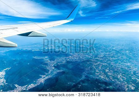 Wing Of Airplane Flying Above European Mountains