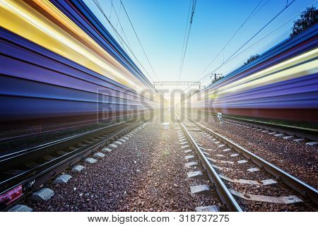 Two Trains Move Fast To The Different Directions At Sunset Time.