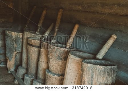 Old Wooden Mortars With Pistils In Them. Old Home Utensils  For Grains Grinding.