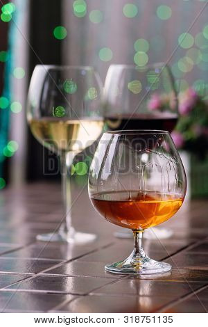 Brandy In Typical Snifter. Cognac In Elegant Glass With Space For Text On Colorful Background. Two G