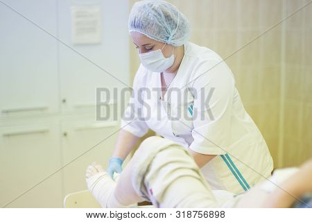 Belarus, Gomel, June 1, 2017. Central Hospital. Nurse Bandages The Leg. Fracture Of Human Lower Limb