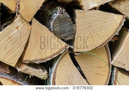 Natural Organic Wooden Cut Logs Background - Closeup Of Chopped Firewood. Firewood Stacked And Prepa