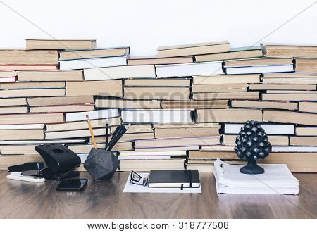 Stack Of Old Book On Wooden Table, Notebook, Smartphone, Stationery And Paperweight. Education Write