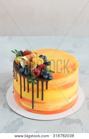 Bright Cake With Chocolate Smudge And Fresh Berries