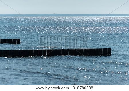 Breakwater On Beach. Wooden Sea Separator. Beautiful Seascape. Protection Holidaymakers From Effects