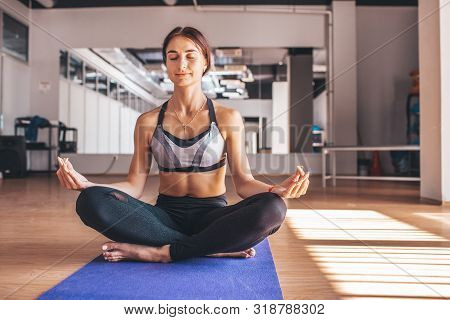Yogi Woman Practicing Yoga Lesson, Breathing, Meditating, Doing Ardha Padmasana Exercise, Half Lotus