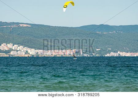 Sunny Beach, Bulgaria July 13, 2019. The Man Practices Hydrofoil Kitesurfing In The Black Sea Off Th