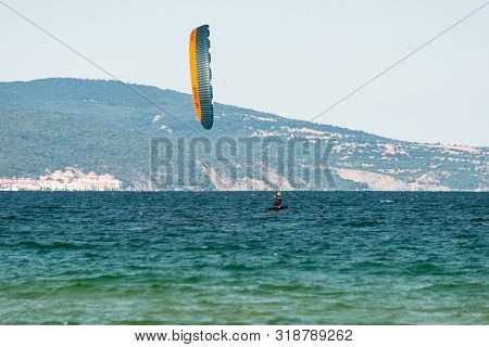Sunny Beach, Bulgaria July 13, 2019. The Man Practices Hydrofoil Kitesurfing In The Black Sea Off Th