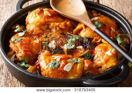 Moroccan Chicken With Eggplant, Tomatoes, And Almonds Closeup On A Plate. Horizontal