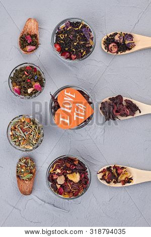I Love Tea Concept. Differnet Kinds Of Dried Tea On Gray Background, Top View.