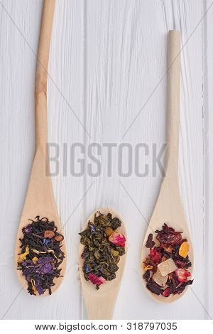 Spoons With Different Types Of Dry Tea Leaves. Mix Of Dried Tea Leaves In The Three Wooden Spoons. T