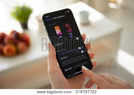 Anapa, Russia - July 22, 2019: Woman Hand Holding Iphone X With Ios 13 And Dark Mode Settings. Iphon
