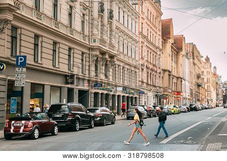 Riga, Latvia - June 9, 2019: People Cross The Road On The Dzirnavu Iela Street. Young Woman Walking 
